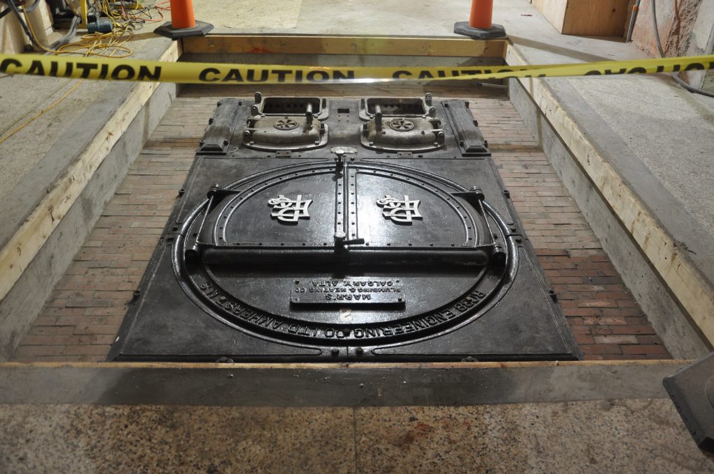 These unforgettable cast-iron artifacts have been carefully cleaned and set upon a bed of historic bricks for their ongoing preservation.