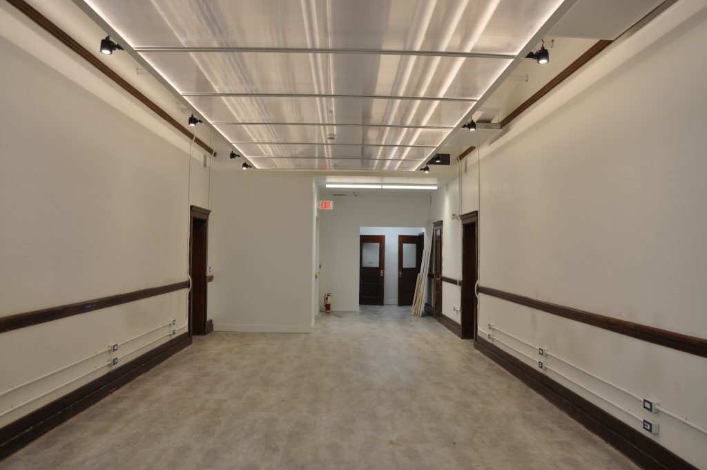 The hallways have been outfitted with ceiling “cloud” transparent polycarbonate panels and flexible gallery lighting to ensure the hallway gallery spaces become the perfect backdrops for shows, exhibitions and sales.